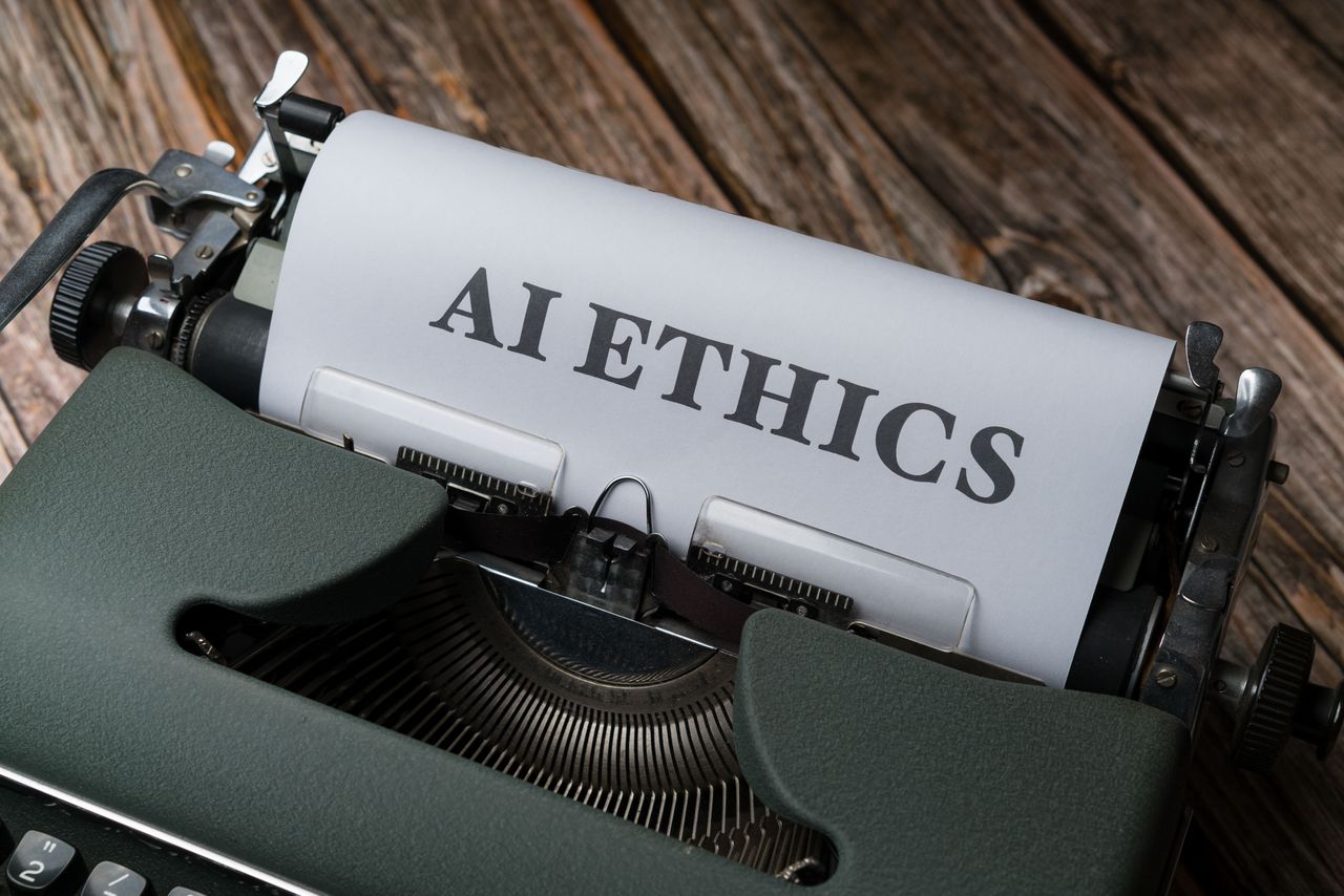 Home Retro typewriter with 'AI Ethics' on paper, conveying technology themes.