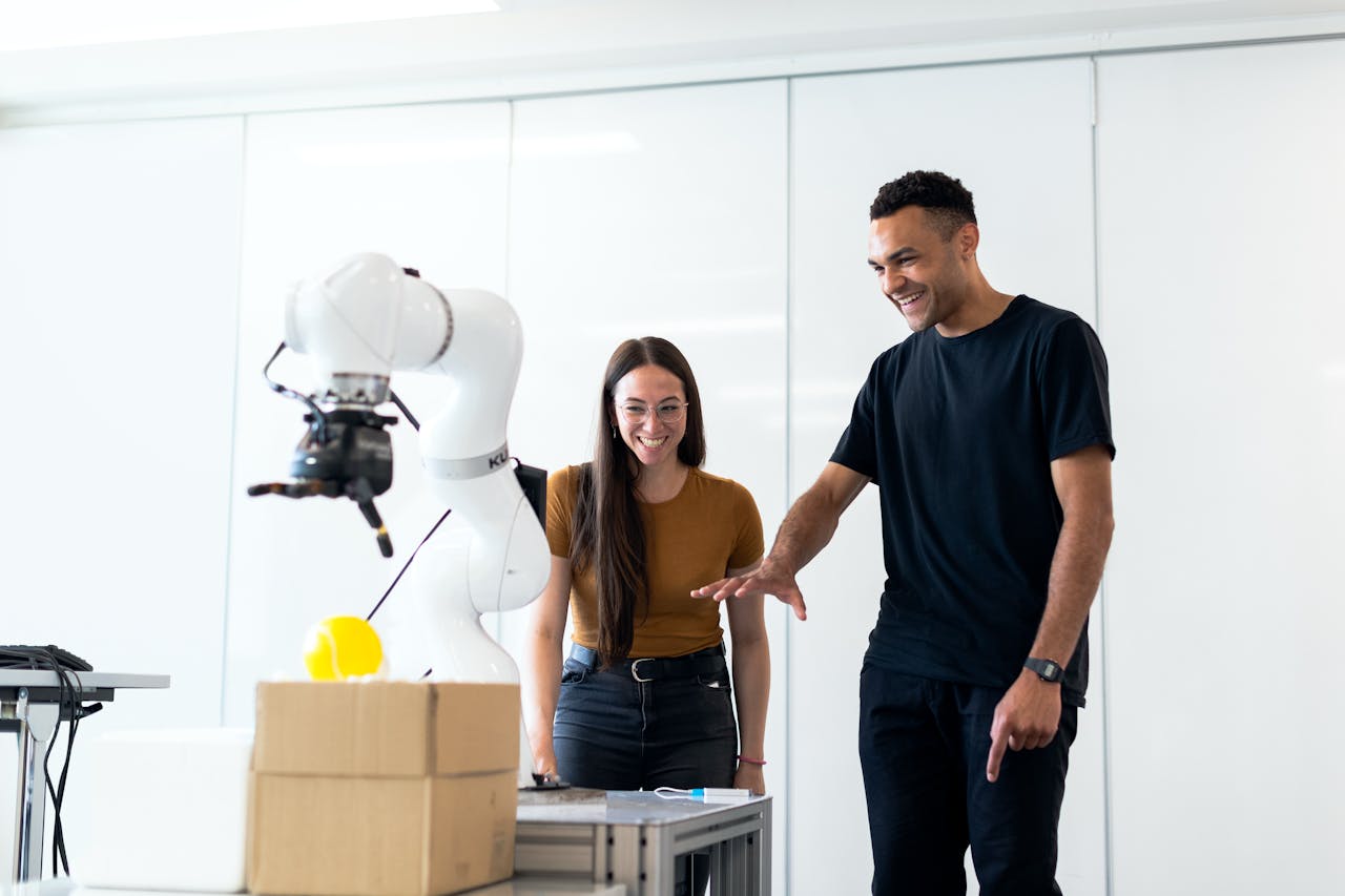 About Two engineers collaborating on testing a futuristic robotic prototype in a modern indoor lab.